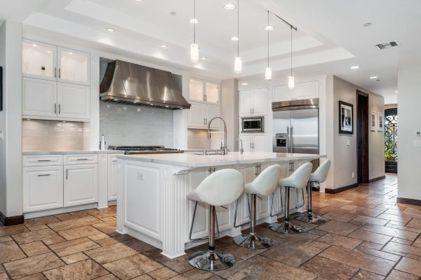 an open kitchen with four bars and stools in it