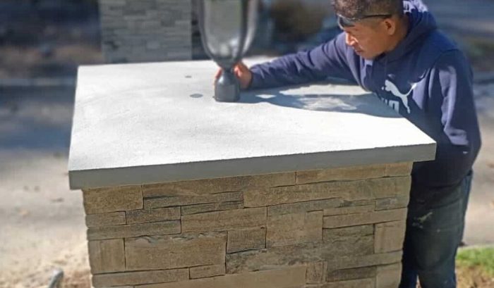Tacupro employee installing modern lighting fixture during a professional home remodeling project